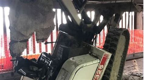 cleveland skid steer falls through parking garage|Worker injured when excavator falls inside Cleveland parking .